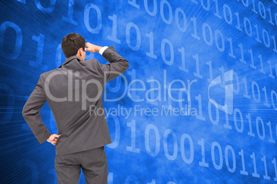 Composite image of businessman standing hand on hip