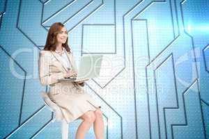 Composite image of smiling businesswoman sitting and using lapto