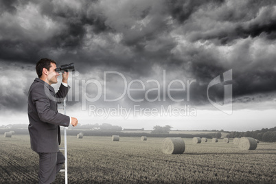 Composite image of businessman standing on ladder