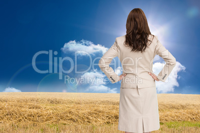 Composite image of businesswoman standing back to camera