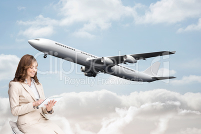 Composite image of happy businesswoman using tablet