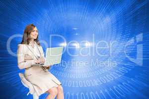 Composite image of smiling businesswoman sitting and using lapto