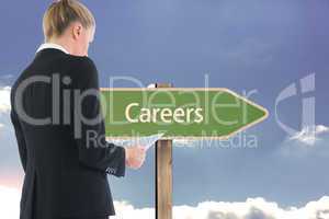 Composite image of businesswoman holding tablet