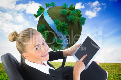 Composite image of businesswoman sitting on swivel chair with ta