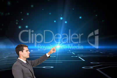 Composite image of businessman sitting and pointing the finger