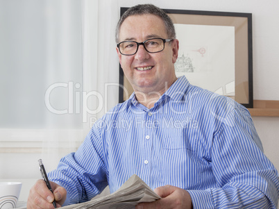 man reading the newspaper in his spare time