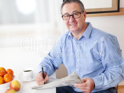 man reading the newspaper in his spare time