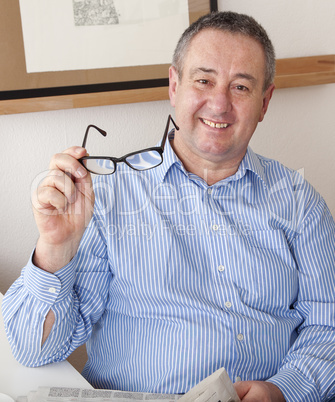 man reading the newspaper in his spare time