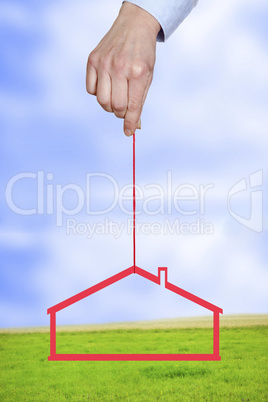 hand holding house on the cord