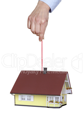 hand holding house on the cord