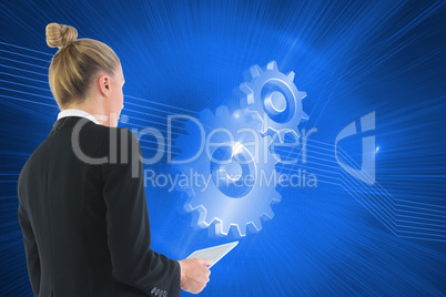 Composite image of businesswoman holding tablet