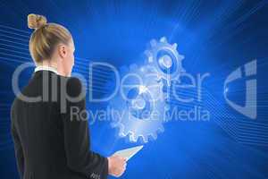 Composite image of businesswoman holding tablet