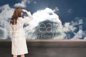 Composite image of rear view of young businesswoman looking away