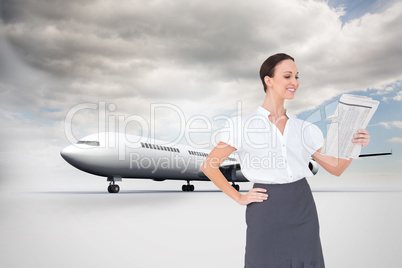 Composite image of cheerful stylish businesswoman holding newspa