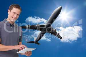 Composite image of smiling young man with tablet computer