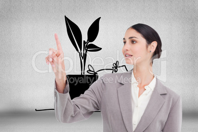 Composite image of young saleswoman operating touchscreen
