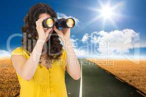 Composite image of casual young woman using binoculars