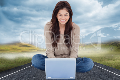 Composite image of woman sitting on the bed with the laptop in f