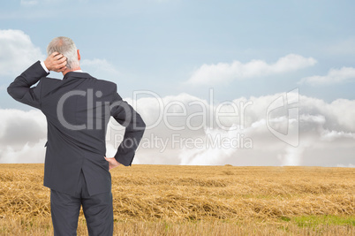 Composite image of rear view of doubtful mature businessman