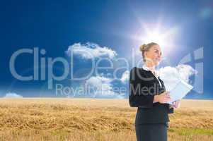 Composite image of businesswoman holding new tablet