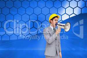 Composite image of young architect yelling with a megaphone