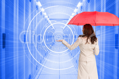 Composite image of businesswoman holding umbrella