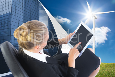 Composite image of businesswoman sitting on swivel chair with ta