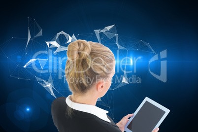 Composite image of businesswoman holding tablet