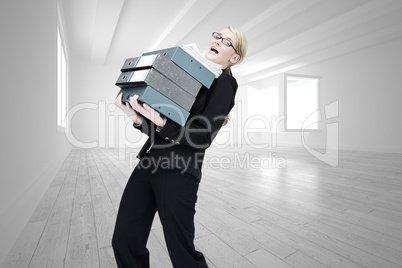 Composite image of businesswoman carrying folders