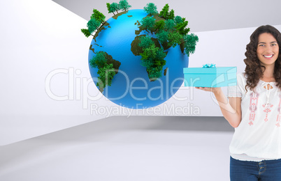 Composite image of content casual brunette holding a present