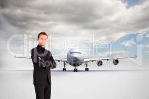 Composite image of handsome businessman with crossed arms