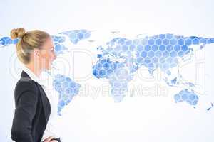 Composite image of businesswoman standing with hands on hips