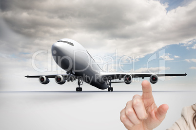 Composite image of businesswoman touching invisible screen