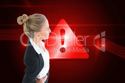 Composite image of businesswoman standing with hands on hips