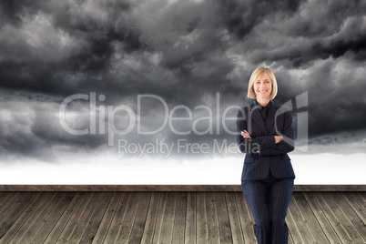 Composite image of friendly businesswoman smiling at the camera