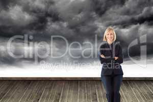 Composite image of friendly businesswoman smiling at the camera