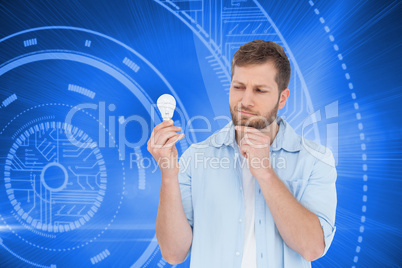 Composite image of sceptical model holding a bulb