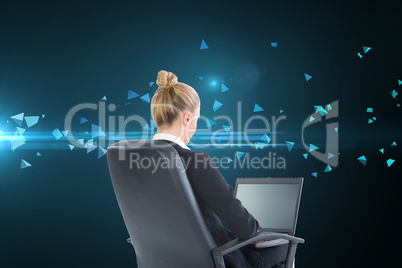 Composite image of businesswoman sitting on swivel chair with la