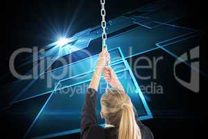 Composite image of businesswoman pulling a chain