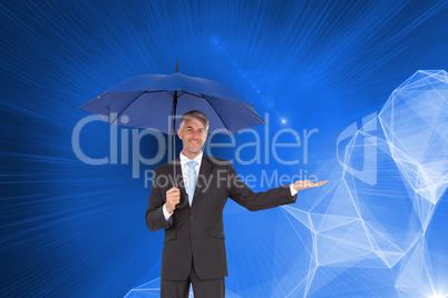 Composite image of peaceful businessman holding blue umbrella