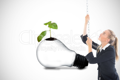 Composite image of businesswoman pulling a chain