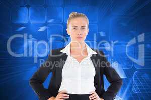 Composite image of businesswoman standing with hands on hips