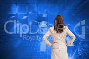 Composite image of businesswoman standing back to camera