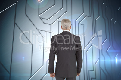 Composite image of businessman walking away from camera