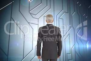 Composite image of businessman walking away from camera