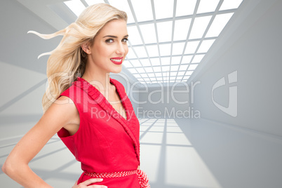 Composite image of smiling blonde standing hands on hips
