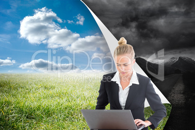 Composite image of businesswoman using laptop