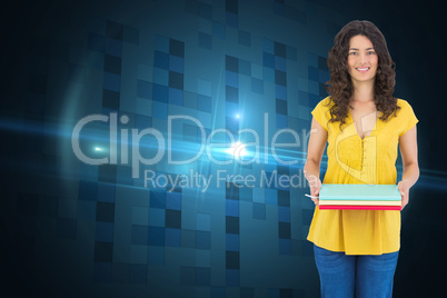Composite image of smiling curly haired brunette holding noteboo