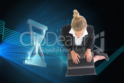 Composite image of businesswoman using laptop