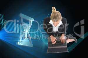 Composite image of businesswoman using laptop